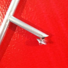 Tiny aluminum tubing, led, and the head of a rivet ground down to make the reflector.